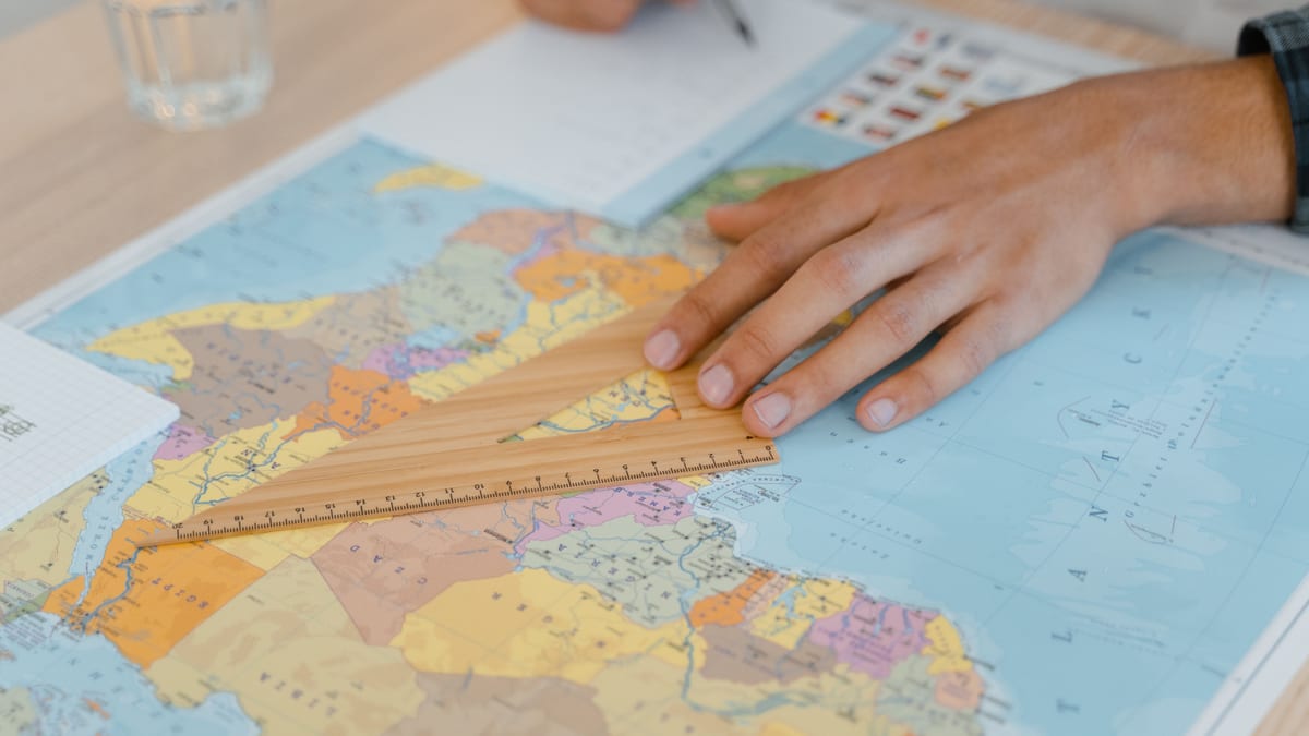 Hand resting on a world map