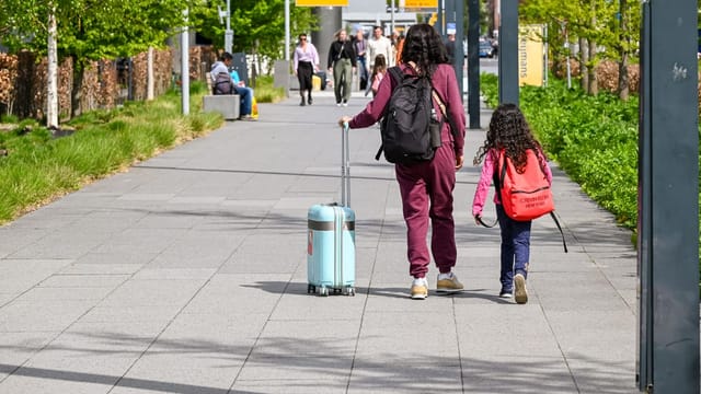 Children pulling a suitcase