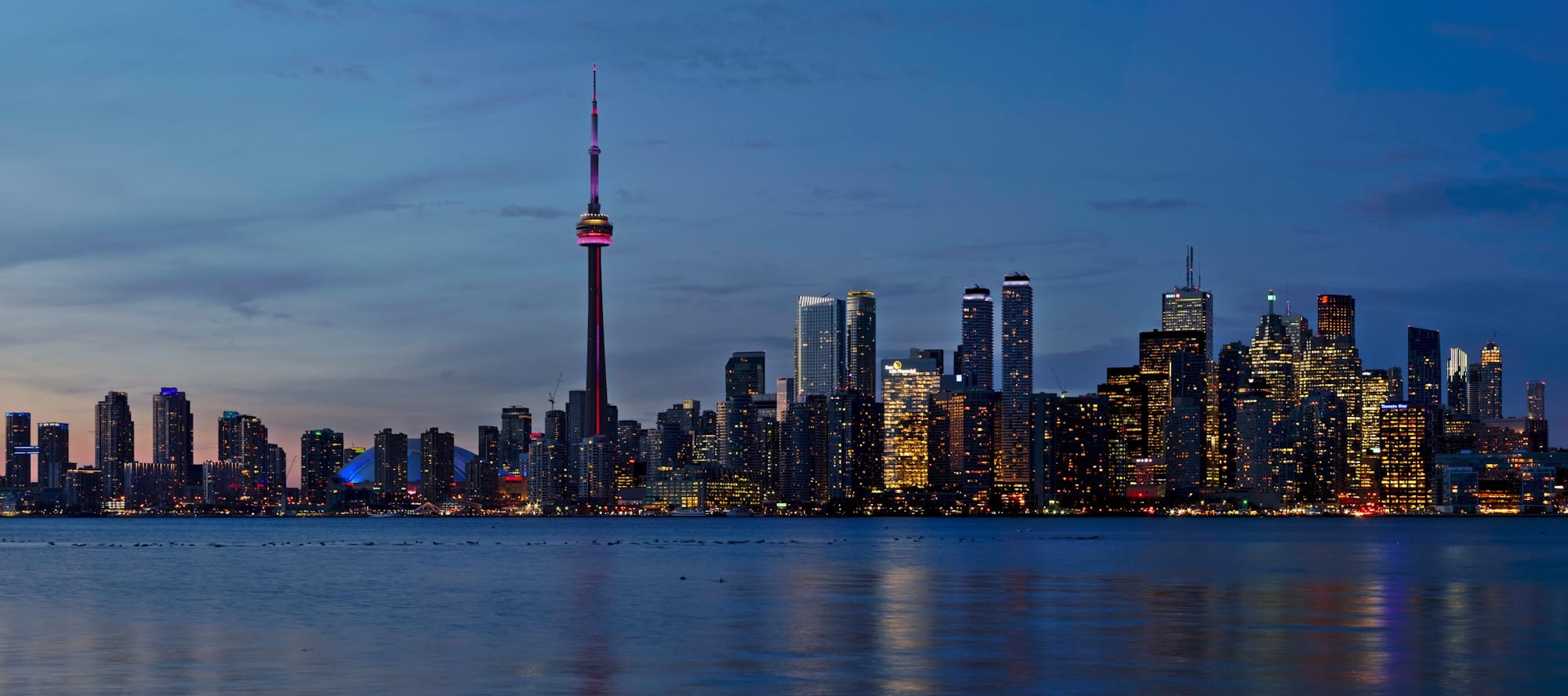 The CN Tower and the Toronto skyline at dusk, seen from Lake Ontario