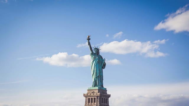 The Statue of Liberty against a blue sky, New York